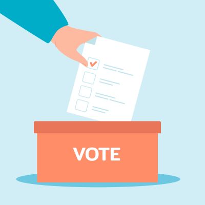 Hand putting in a ballot paper in a voting box